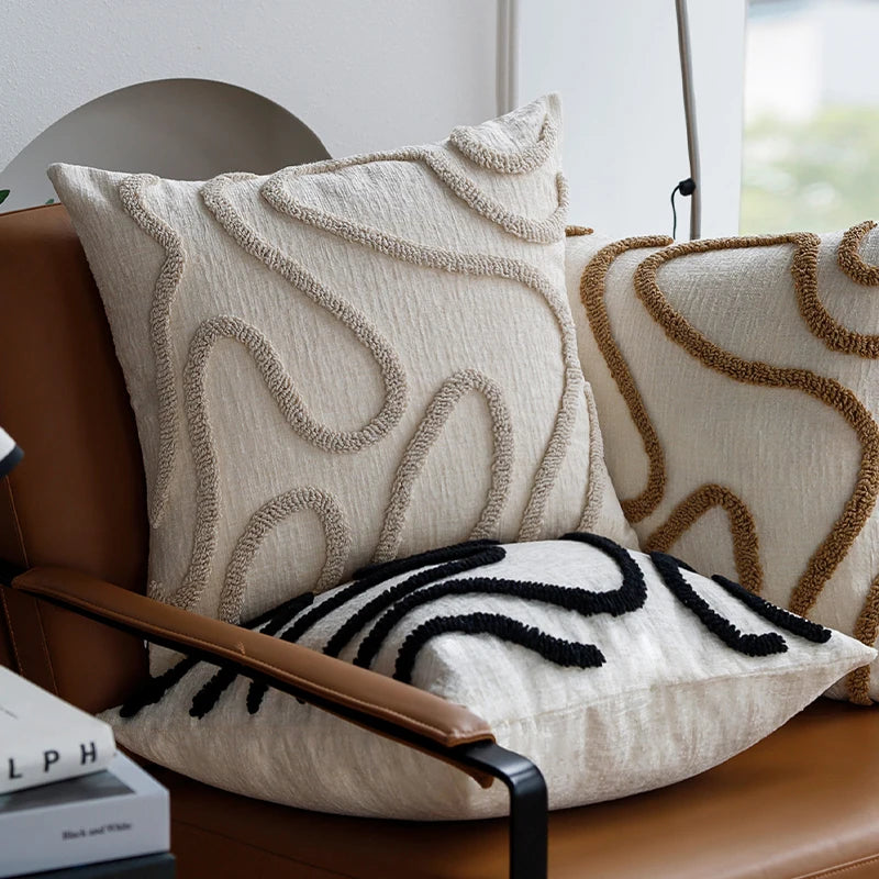 CHENILLE — Trois housses de coussin en chenille à lignes abstraites sur un fauteuil