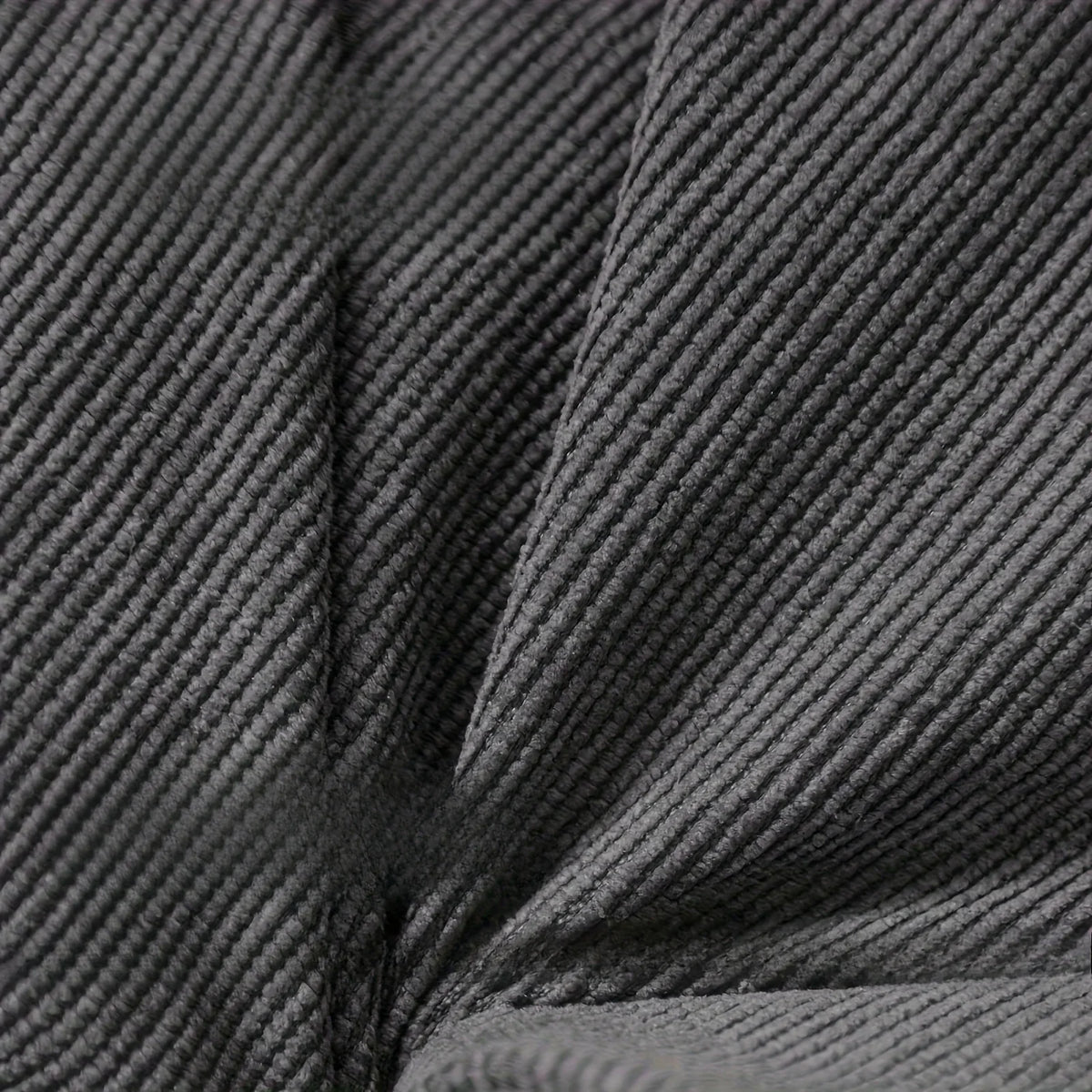 OEUF — Gros plan sur le tissu gris foncé côtelé du coussin